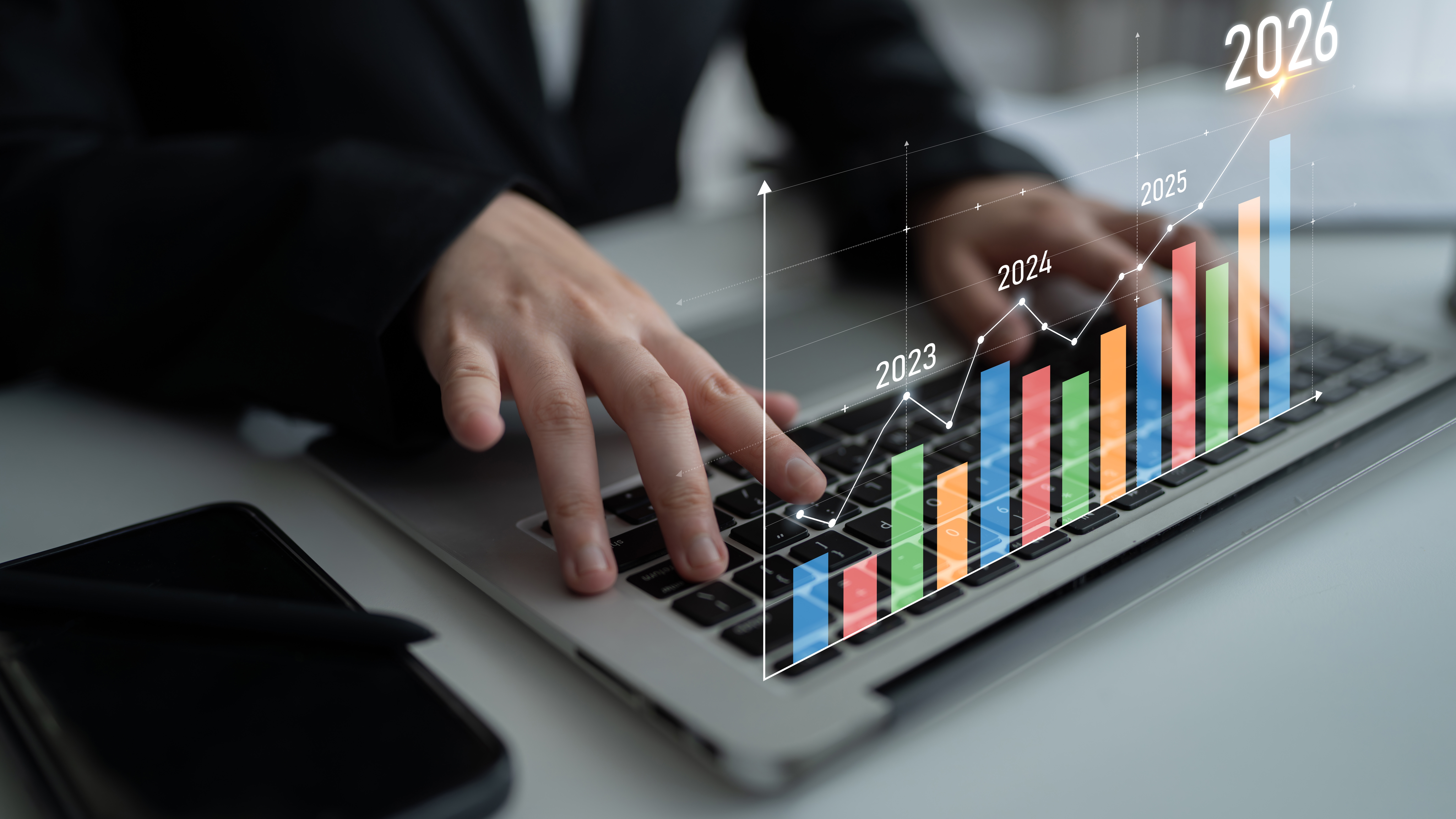 A laptop showing graphs with an ascending arrow showing a direct marketing success.